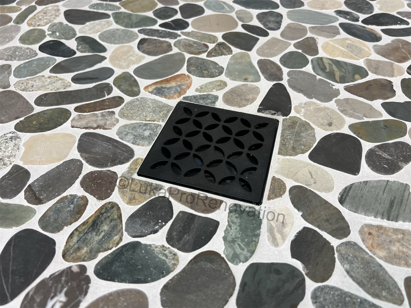 River stone floor with decorative drain