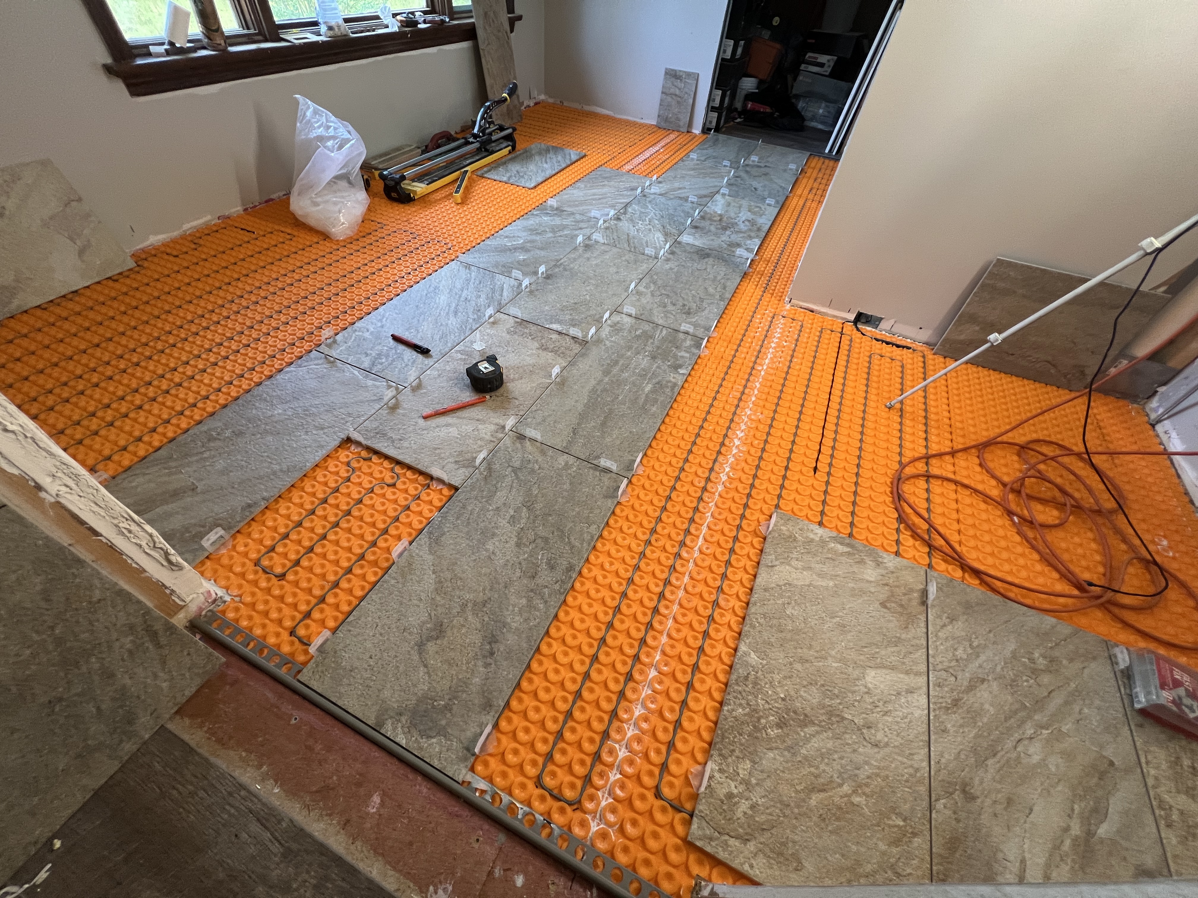 Heated floor tile installation