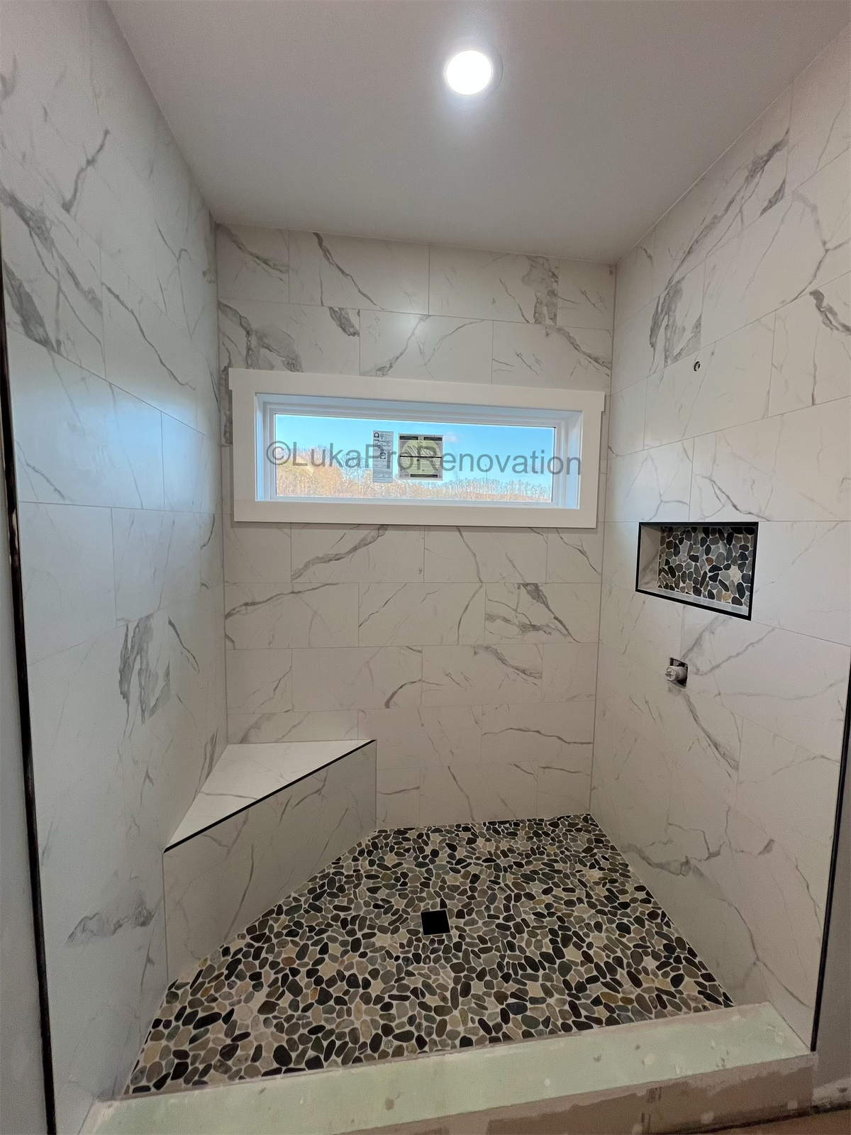 Calacatta shower with river stone floor