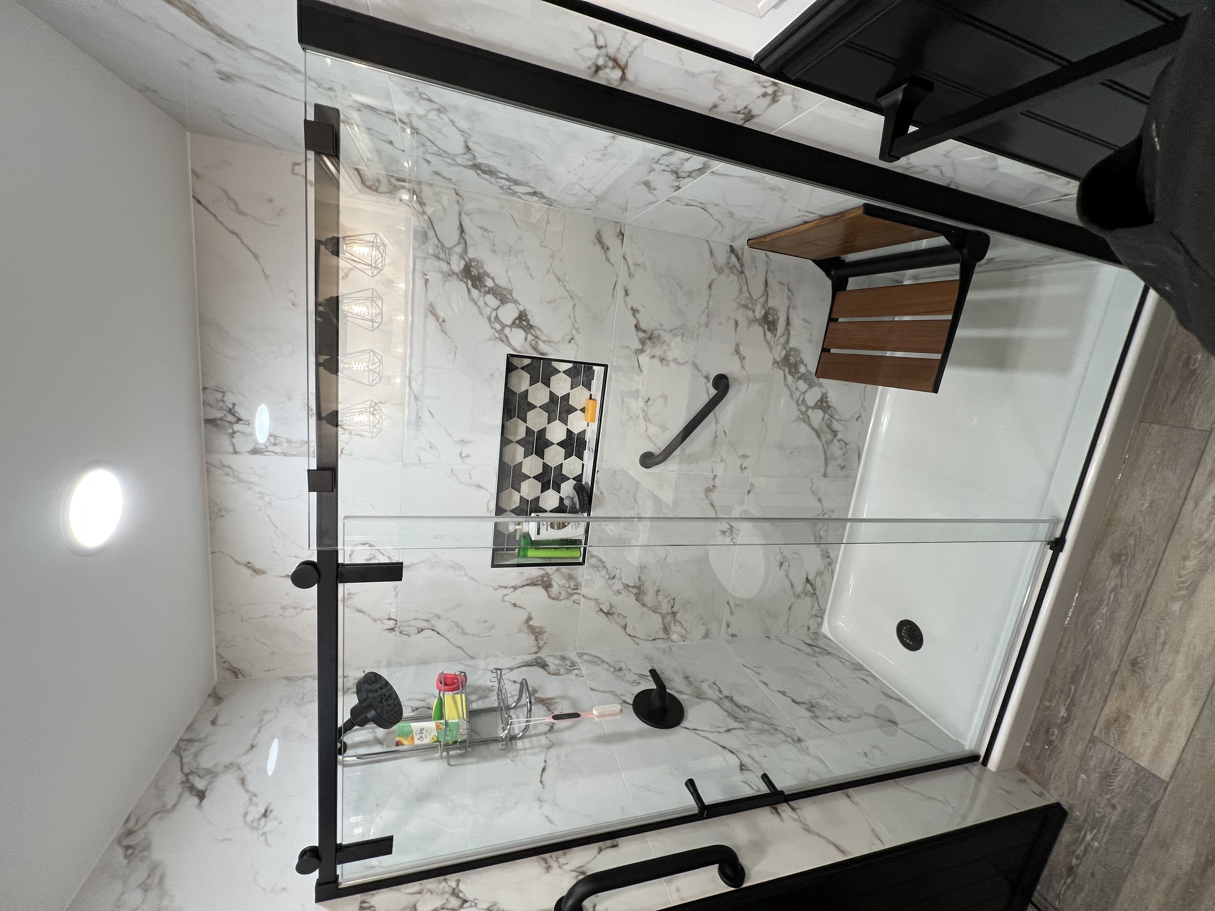 Marble shower with barn door glass