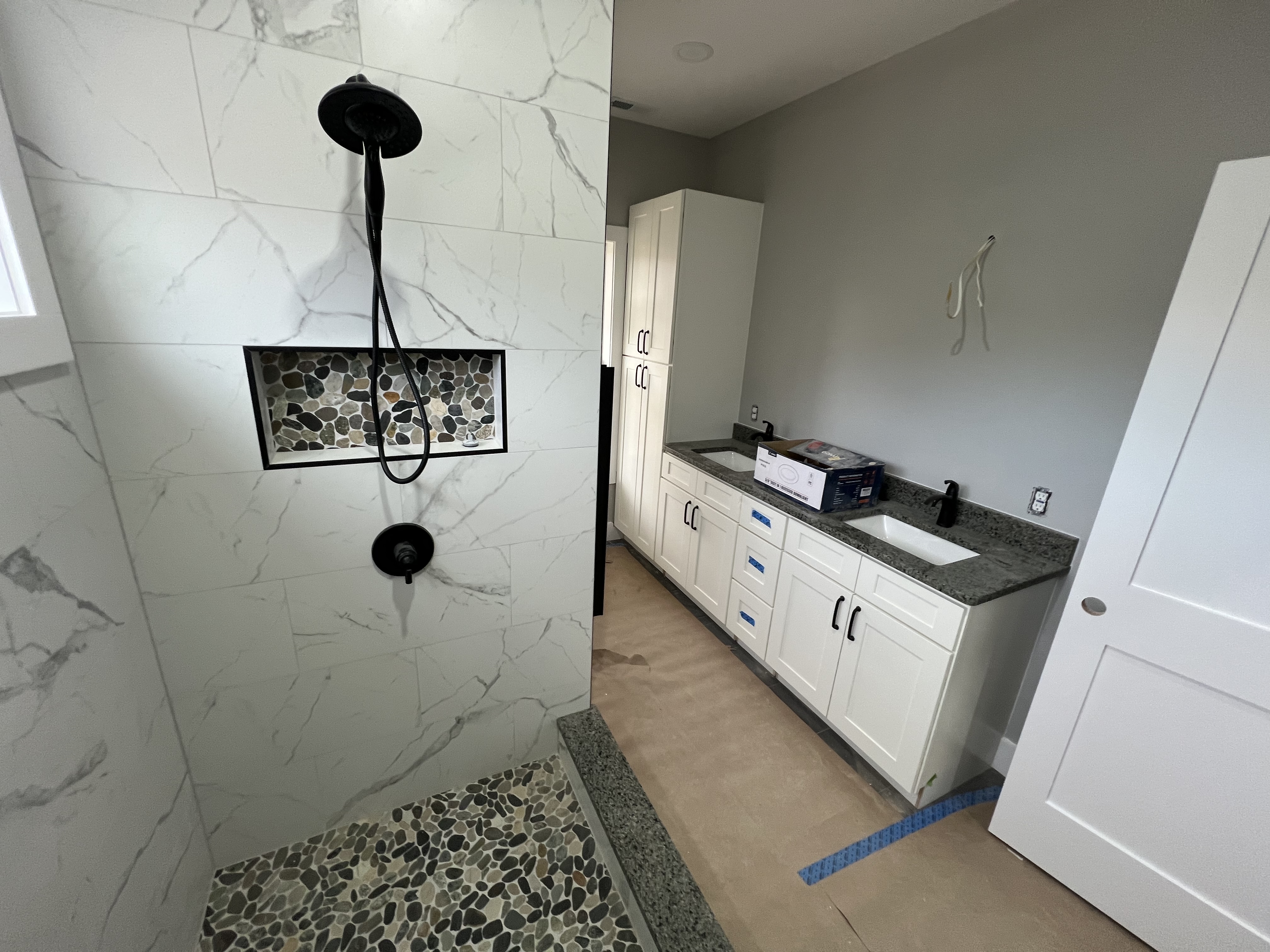 Walk-in shower with river stone floor