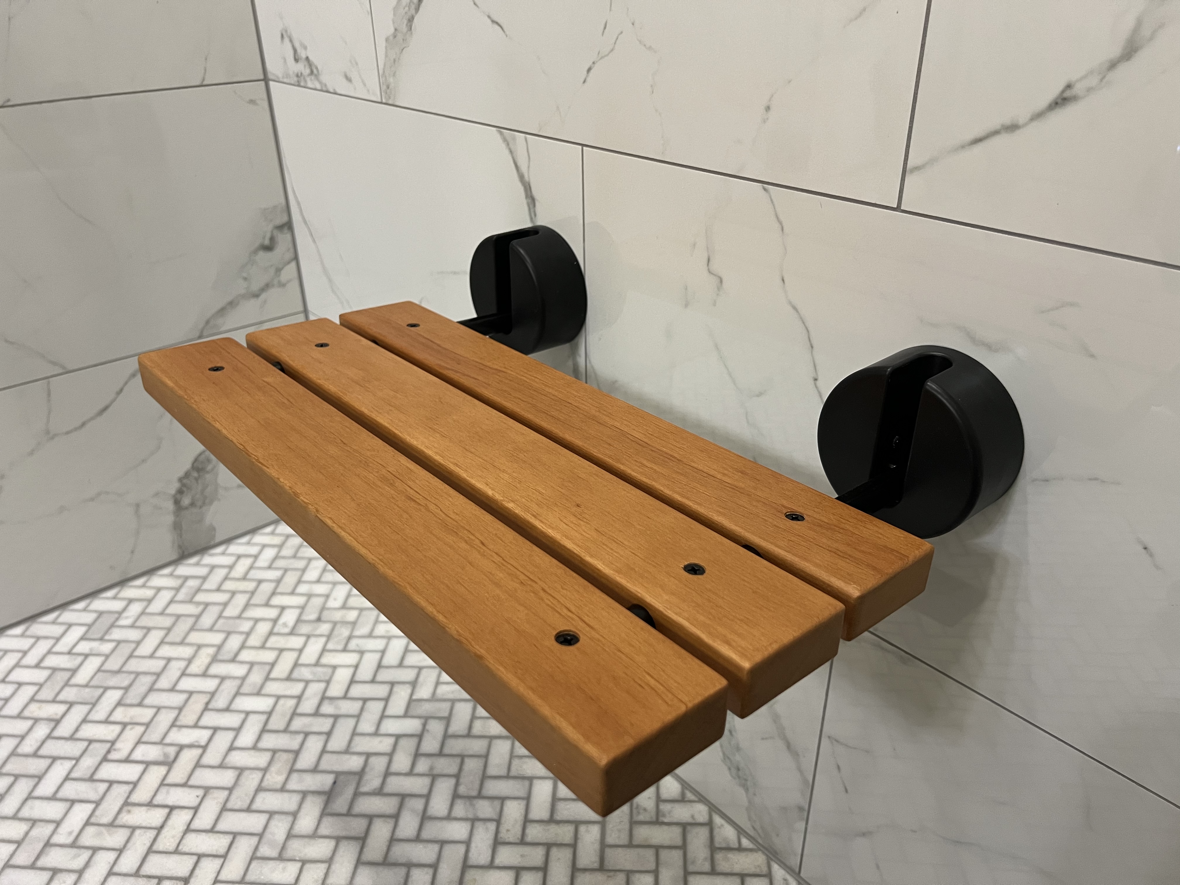 Wall mounted teak shower bench with matte black hardware